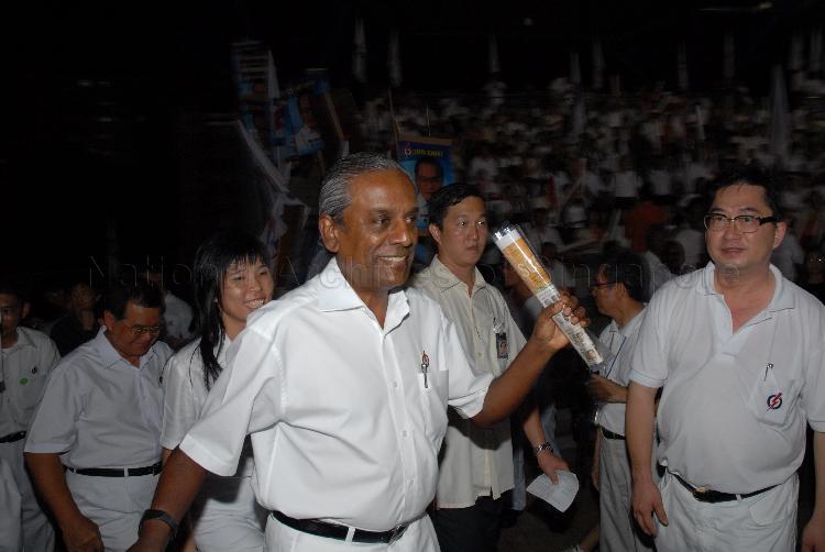 People's Action Party (PAP) candidate for East Coast Group Representation Constituency (GRC) Professor S Jayakumar arriving at Serangoon stadium, the assembly centre for PAP and their supporters during Singapore General Election. Behind him is Ms Jessica Tan Soon Neo, one of the PAP candidates for East Coast GRC.