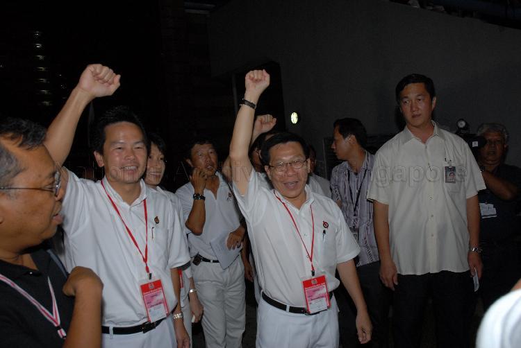 People's Action Party (PAP) candidates for Tampines Group Representation Constituency (GRC) Mah Bow Tan (right), Ms Irene Ng Phek Hoong (partially hidden) and Ong Kian Min at Serangoon stadium, the assembly centre for PAP and their supporters during Singapore General Election