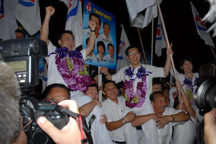 People's Action Party (PAP) candidates for Tampines Group Representation Constituency (GRC) Sin Boon Ann (left), Mah Bow Tan (centre) and Ms Irene Ng Phek Hoong being chaired by supporters at Serangoon stadium after their victory during Singapore General Election. The stadium was assembly centre for PAP and their supporters.