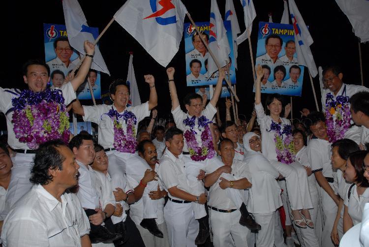 People's Action Party (PAP) candidates for Tampines Group Representation Constituency (GRC), from left, Sin Boon Ann, Ong Kian Min, Mah Bow Tan, Ms Irene Ng Phek Hoong and Masagos Zulkifli bin Masagos Mohamad being chaired by supporters at Serangoon stadium after their victory during Singapore General Election. The stadium was assembly centre for PAP and their supporters.