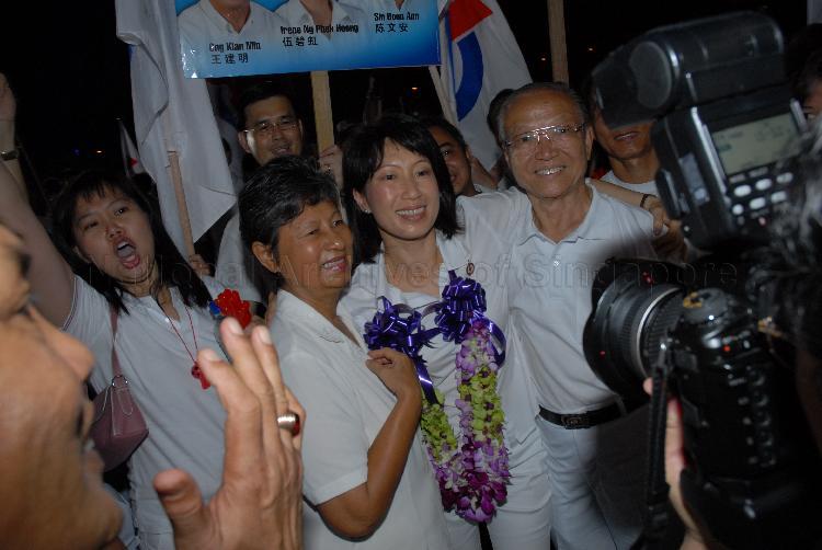 People's Action Party (PAP) candidate for Tampines Group Representation Constituency (GRC) Ms Irene Ng Phek Hoong (garlanded) posing for a group photograph at Serangoon stadium after her victory during Singapore General Election. The stadium was assembly centre for PAP and their supporters.