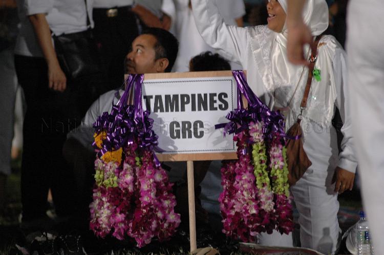 Close-up view of garlands hanging on signboard of Tampines Group Representation Constituency (GRC) at Serangoon stadium, the assembly centre for People's Action Party (PAP) and their supporters