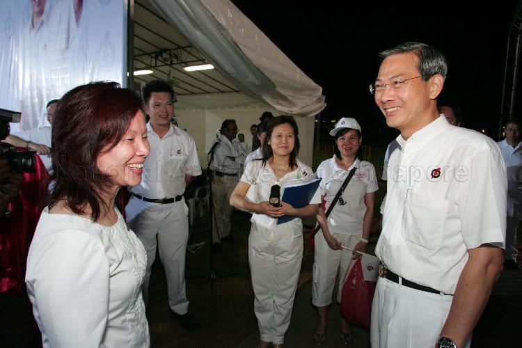 People's Action Party (PAP) candidates for Jalan Besar Group Representation Constituency (GRC) Dr Lee Boon Yang and for West Coast GRC Ms Ho Geok Choo (left) at Serangoon stadium, the assembly centre for PAP and their supporters during Singapore General Election