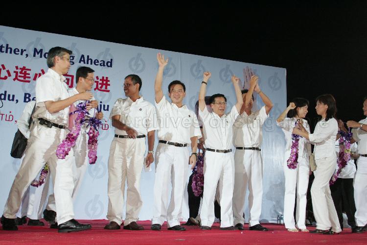 People's Action Party (PAP) candidates for Tampines Group Representation Constituency (GRC) Masagos Zulkifli bin Masagos Mohamad (third from left), Sin Boon Ann, Mah Bow Tan and Ms Irene Ng Phek Hoong with PAP members on the stage at Serangoon stadium after their victory during Singapore General Election. The stadium was assembly centre for PAP and their supporters.