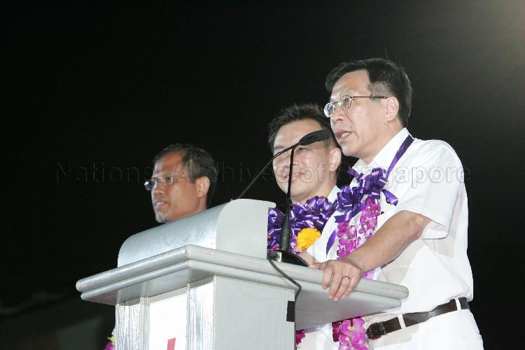 People's Action Party (PAP) candidates for Tampines Group Representation Constituency (GRC), from right, Mah Bow Tan, Sin Boon Ann and Masagos Zulkifli bin Masagos Mohamad on the stage at Serangoon stadium to address supporters after their victory during Singapore General Election. The stadium was assembly centre for PAP and their supporters.