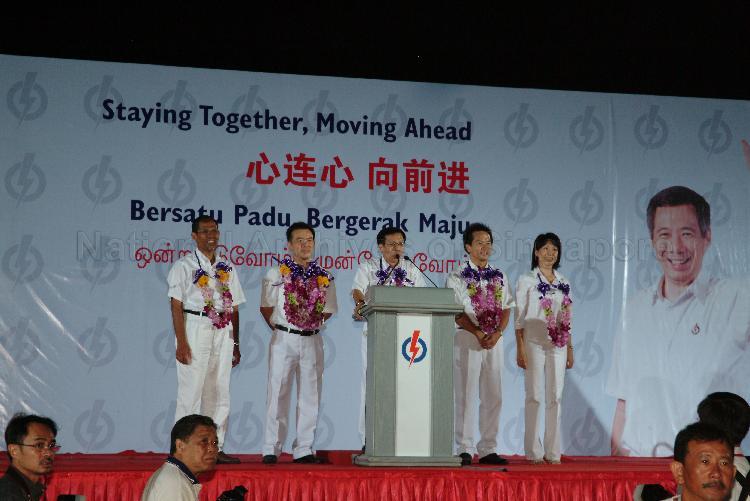 People's Action Party (PAP) candidates for Tampines Group Representation Constituency (GRC), from left, Masagos Zulkifli bin Masagos Mohamad, Sin Boon Ann, Mah Bow Tan, Ong Kian Min and Ms Irene Ng Phek Hoong on the stage at Serangoon stadium to address supporters after their victory during Singapore General Election. The stadium was assembly centre for PAP and their supporters.
