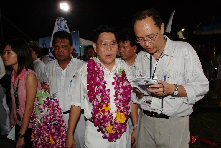 People's Action Party (PAP) candidate for Aljunied Group Representation Constituency (GRC) Yeo Guat Kwang (garlanded) speaking to a reporter at Serangoon stadium after his victory during Singapore General Election. The stadium was assembly centre for PAP and their supporters.