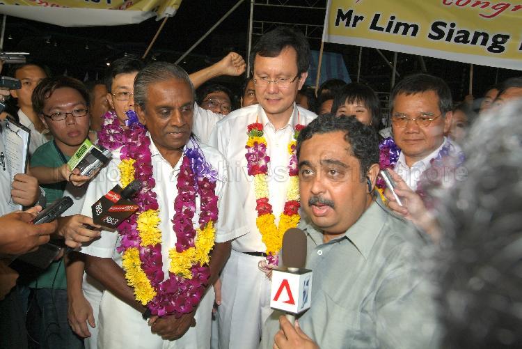 People's Action Party (PAP) candidates for East Coast Group Representation Constituency (GRC) Professor S Jayakumar, Raymond Lim Siang Keat and Abdullah Tarmugi at an interview by Channel NewsAsia (CNA) reporter S Ramesh at Serangoon stadium after their victory during Singapore General Election. The stadium was assembly centre for PAP and their supporters.