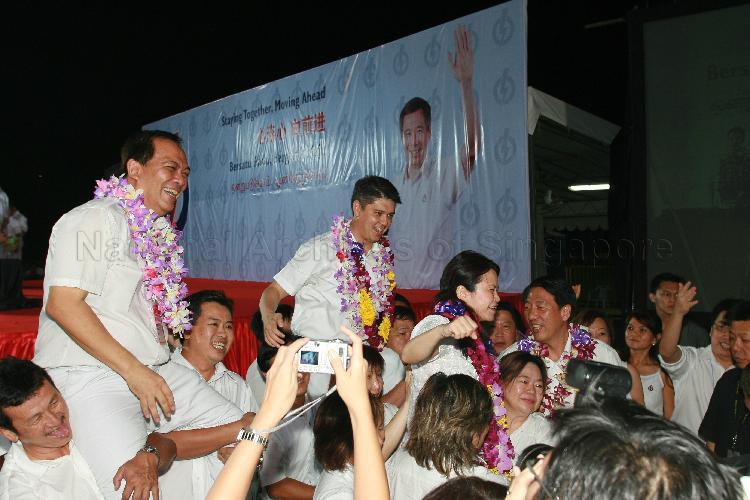 People's Action Party (PAP) candidates (garlanded) for Pasir Ris-Punggol Group Representation Constituency (GRC), from left, Charles Chong You Fook, Michael Anthony Palmer, Ms Penny Low and Teo Chee Hean with supporters at Woodlands stadium after their victory during Singapore General Election. The stadium was assembly centre for PAP and their supporters.