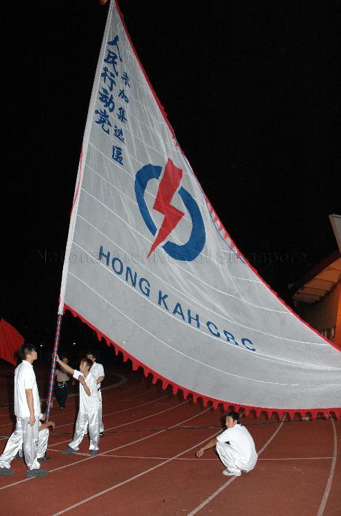 Supporters displaying giant People's Action Party (PAP) flag for Hong Kah Group Representation Constituency (GRC) at Woodlands stadium, the assembly centre for PAP and their supporters during Singapore General Election