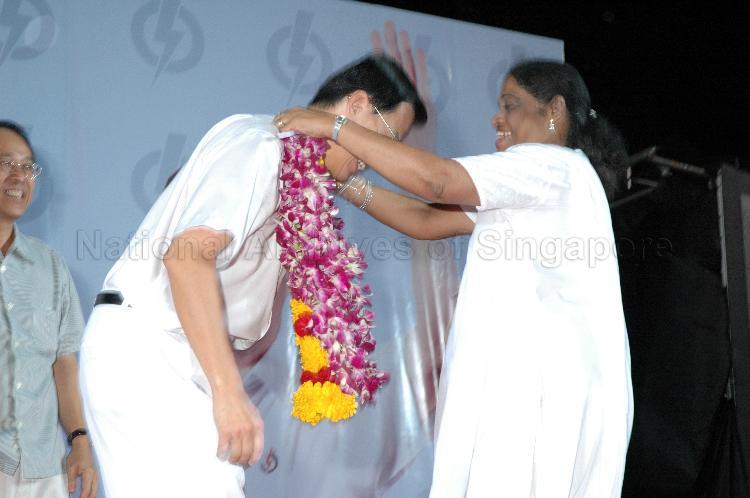 People's Action Party (PAP) candidate for Bukit Panjang Dr Teo Ho Pin being garlanded by supporter on the stage at Woodlands stadium, the assembly centre for PAP and their supporters during Singapore General Election