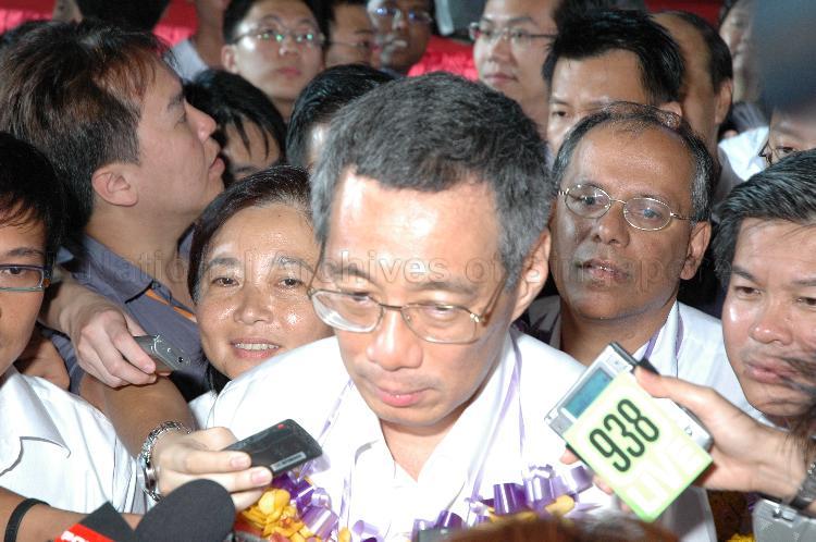Close-up view of People's Action Party (PAP) candidate for Ang Mo Kio Group Representation Constituency (GRC) Lee Hsien Loong during interview by the media at Woodlands stadium, the assembly centre for PAP and their supporters during Singapore General Election. With him are his GRC team members are Ms Lee Bee Wah (left), Dr Balaji Sadasivan and Wee Siew Kim.