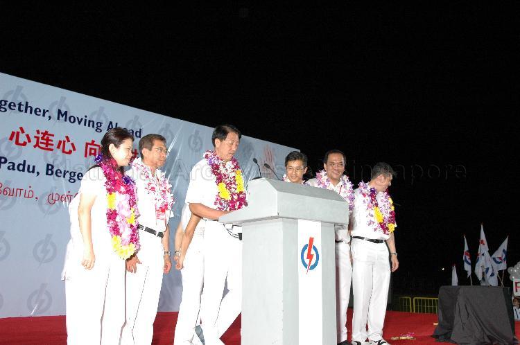 People's Action Party (PAP) candidates for Pasir Ris-Punggol Group Representation Constituency (GRC), from left, Ms Penny Low, Dr Ahmad bin Mohamed Magad, Teo Chee Hean, Teo Ser Luck, Charles Chong You Fook and Michael Anthony Palmer on the stage at Woodlands stadium to address supporters after their victory during Singapore General Election. The stadium was assembly centre for PAP and their supporters.