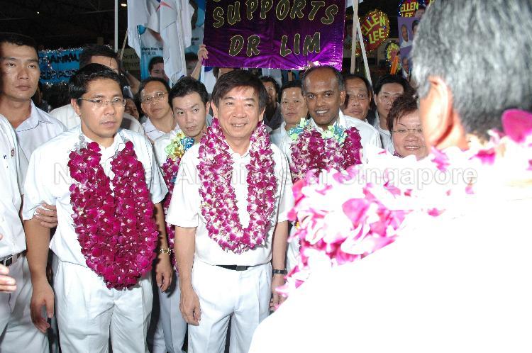People's Action Party (PAP) candidates (garlanded) for Sembawang Group Representation Constituency (GRC), from left, Dr Mohamad Maliki bin Osman, Dr Lim Wee Kiak, Khaw Boon Wan, Shanmugam Kasiviswanathan and Ms Ellen Lee Geck Hoon (partially hidden) at Woodlands stadium, the assembly centre for PAP and their supporters during Singapore General Election