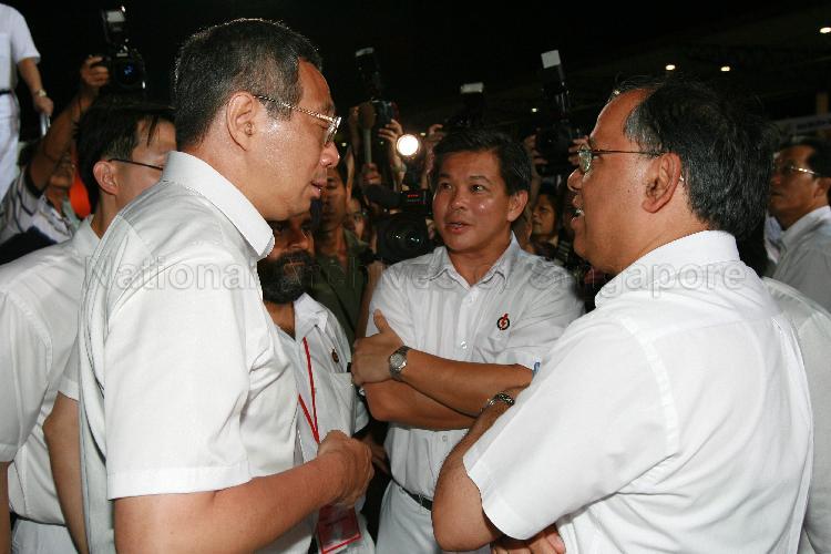 People's Action Party (PAP) candidates for Ang Mo Kio Group Representation Constituency (GRC), from left, Lee Hsien Loong, Inderjit Singh (partially hidden), Wee Siew Kim and Dr Balaji Sadasivan having a chat at Woodlands stadium, the assembly centre for PAP and their supporters during Singapore General Election