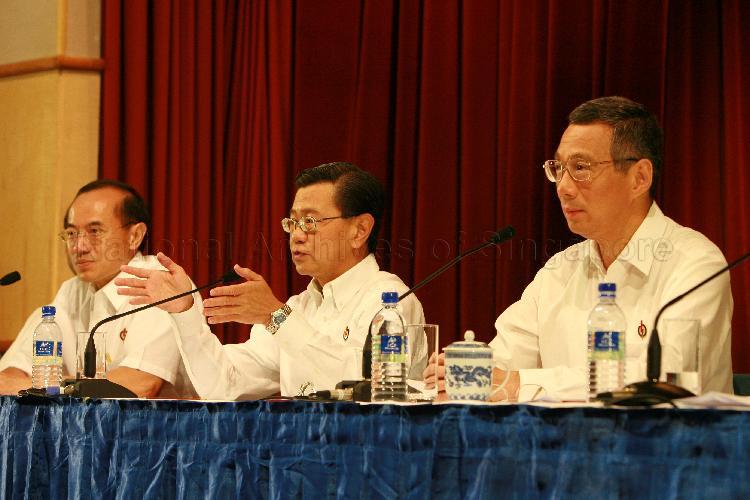 Elected People's Action Party (PAP) Member of Parliament (MP) for Bishan-Toa Payoh Group Representation Constituency (GRC) Wong Kan Seng (centre) speaking at post-election press conference while MP-elect for Ang Mo Kio GRC Lee Hsien Loong and MP-elect for Aljunied GRC George Yeo Yong-Boon look on. The press conference was held at Treasury Building.