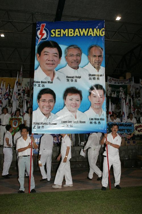 Supporters displaying huge campaign poster of People's Action Party (PAP) candidates for Sembawang Group Representation Constituency (GRC) at Woodlands stadium, the assembly centre for PAP and their supporters during Singapore General Election