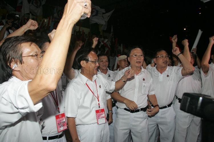 Cheering along with People's Action Party (PAP) members at Woodlands stadium is PAP candidate for Yio Chu Kang Seng Han Thong (second from left). The stadium was assembly centre for PAP and their supporters during Singapore General Election.