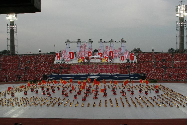 National Day Parade 2006 at National Stadium -- Bird's eye view of mass martial arts display "Youth Explosion", with 600 students from Rulang Primary School forming frame of "birthday cake" with shape of Singapore and 250 soldiers from the 7th Singapore Infantry Brigade, the 41 "candles" inside. This pre-parade item is choreographed by MediaCorp artiste Vincent Ng, who is also performing in it.