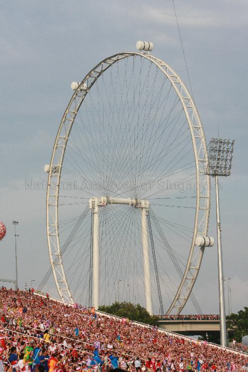 National Day Parade 2007 at Marina Bay -- Spectators with the Singapore Flyer in the Background