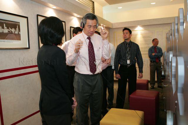 Prime Minister Lee Hsien Loong listening to recollections of lives of Mr Tan Kah Kee and Dr Lee Kong Chian during official launch of â€œThe Legacy of Tan Kah Kee and Lee Kong Chianâ€ exhibition at National Library Building, 100 Victoria Street. The six-month-long exhibition was organised by National Library and Tan Kah Kee Foundation.
