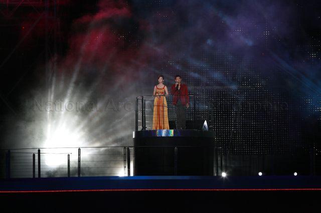 National Day Parade 2008 at Marina Bay - The parade theme song 'Shine for Singapore' being sung by local singer-songwriter Joi Chua (left) and winner of second season of Singapore Idol Hady Mirza