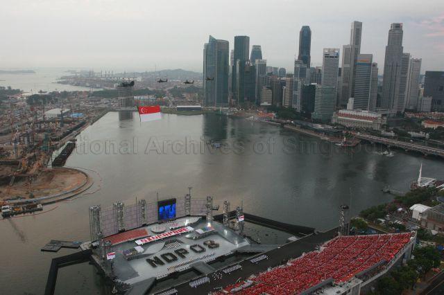National Day Parade 2008 at Marina Bay - Aerial view of spectator stands and floating platform with the phrase 'NDP 08' formed by contingents, during State Flag flypast by Republic of Singapore Air Force (RSAF)