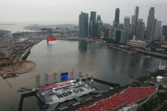 National Day Parade 2008 at Marina Bay - Aerial view of spectator stands and floating platform with the phrase 'NDP 08' formed by contingents, during State Flag flypast by Republic of Singapore Air Force (RSAF)