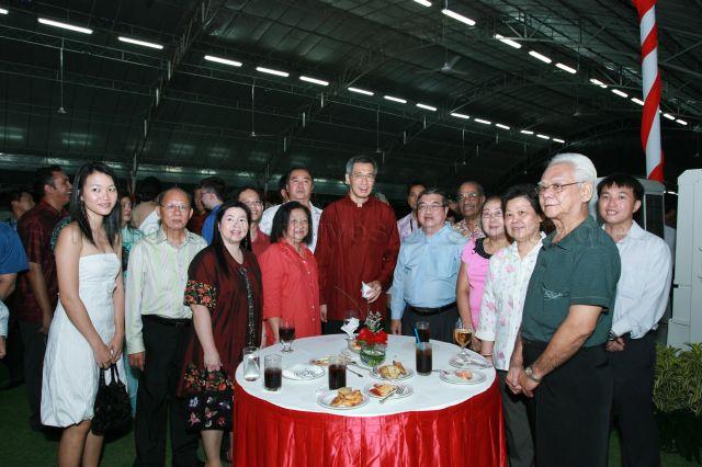 Prime Minister Lee Hsien Loong posing for photograph with guests at National Day reception hosted by President and Mrs S R Nathan at the Istana