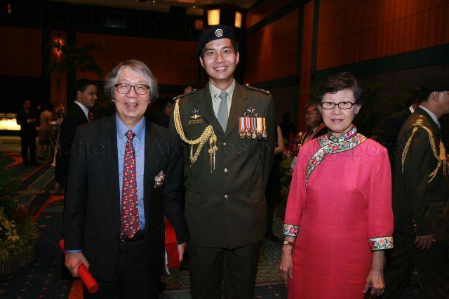 Ambassador-at-Large and recipient of the Order of Nila Utama (First Class) Professor Tommy Koh and his wife, Dr Poh Siew Aing, posing for photographs with Aide-de Camp at the reception during investiture of National Day awards at Suntec City
