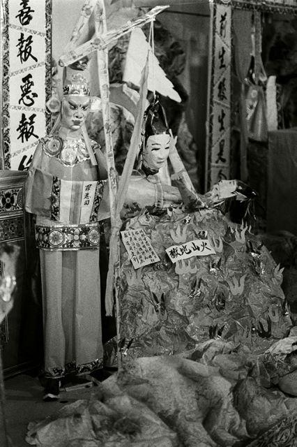Exhumation of Chinese graves at Kampong San Teng cemetery in the 1980s: Paper figurine depicting punishment of the guilty in the afterlife by having molten metal poured over him.