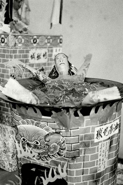 Exhumation of Chinese graves at Kampong San Teng cemetery in the 1980s: Paper figurine depicting a form of punishment of the guilty in the afterlife.