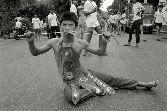 Medium &nbsp;possessed by the deity Sun Wo Kong, with a spike through his cheeks, in temple procession at Redhill