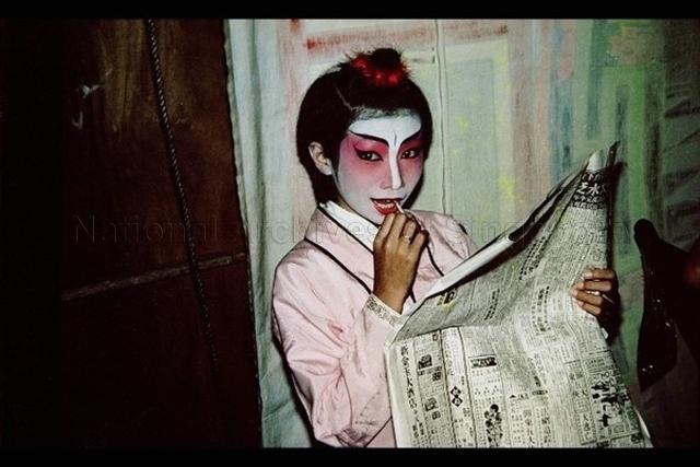 Chinese wayang actress eating a lollipop