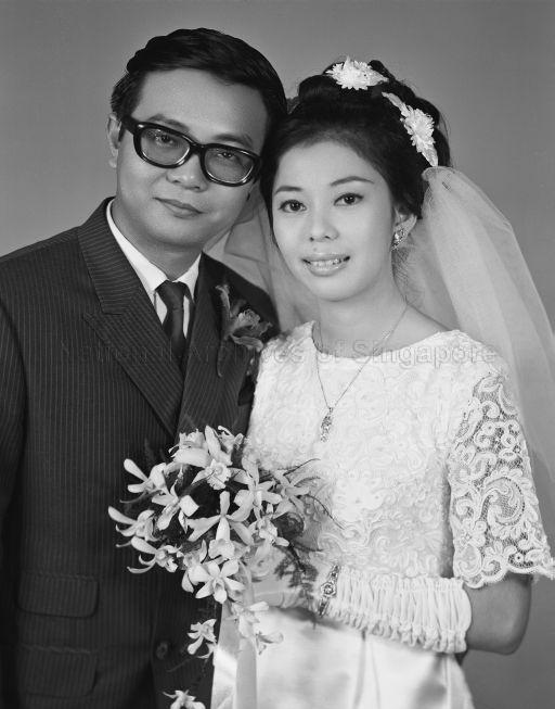 Three-quarter length portrait of bride and groom