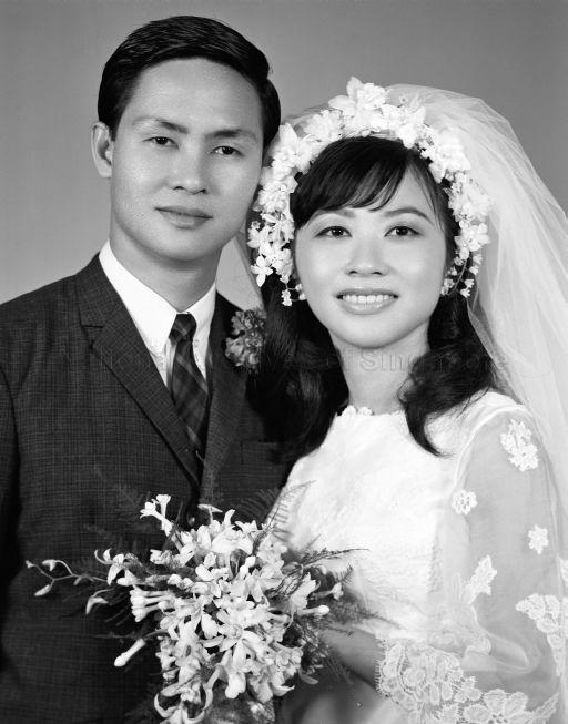 Three-quarter length portrait of bride and groom