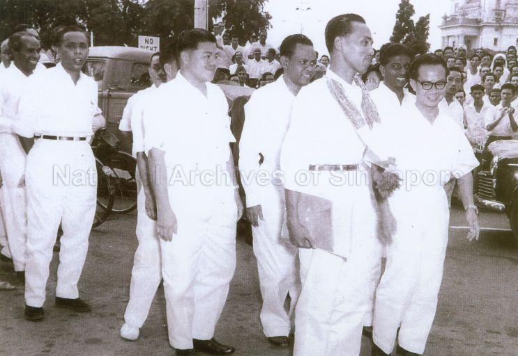 Photo shows People's Action Party (PAP) members at the Anson by-election, with Mahmud Awang (third from right) as the PAP candidate contesting in the by-election. Other members present were Dr Toh Chin Chye, the Chairman of the PAP (extreme right), S Rajaratam, the Minister for Culture (extreme left), and other party supporters. The Anson by-election was held on 15 July 1961 after the sudden death of Baharuddin Bin Mohamed Ariff, the PAP assemblyman in Anson. In the by-election, Mahmud Awang lost to David Marshall of the Workers' Party by 546 votes.