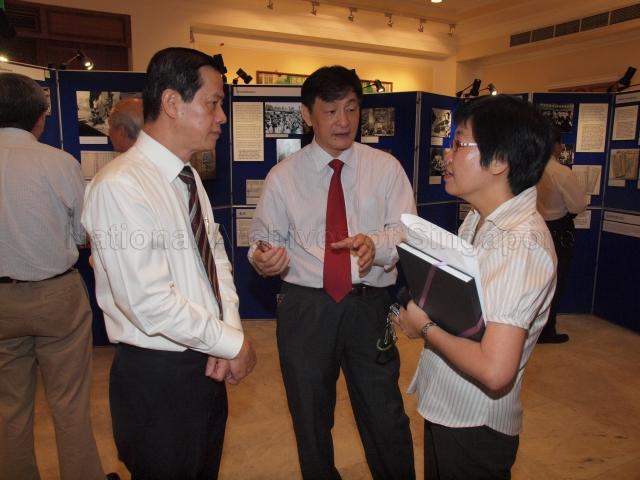 Members of the 55th Council of Singapore Chinese Chamber of Commerce and Industry (SCCCI) Royston Low (left), Wan Shung Ming (CENTRE) and Senior Director of Corporate Resources and Community Services of SCCCI Tan Siew Kiang (right) at opening of "Nanqiao Jigong: The Extraordinary Story of Nanyang Drivers and Mechanics who returned to China during the Sino-Japanese War" travelling exhibition held at Singapore Chinese Chamber of Commerce and Industry auditorium