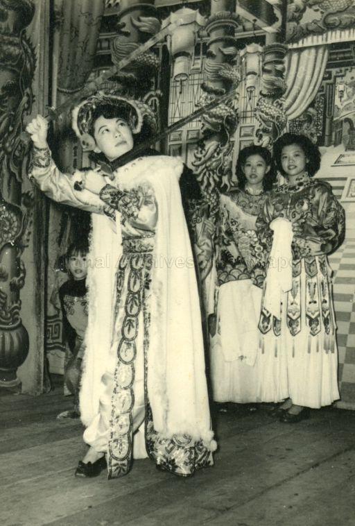 Women in Chinese opera costumes on a typical stage (from album belonging to family of Ena Teh Guat Kheng, daughter of Dr Lim Boon Keng)