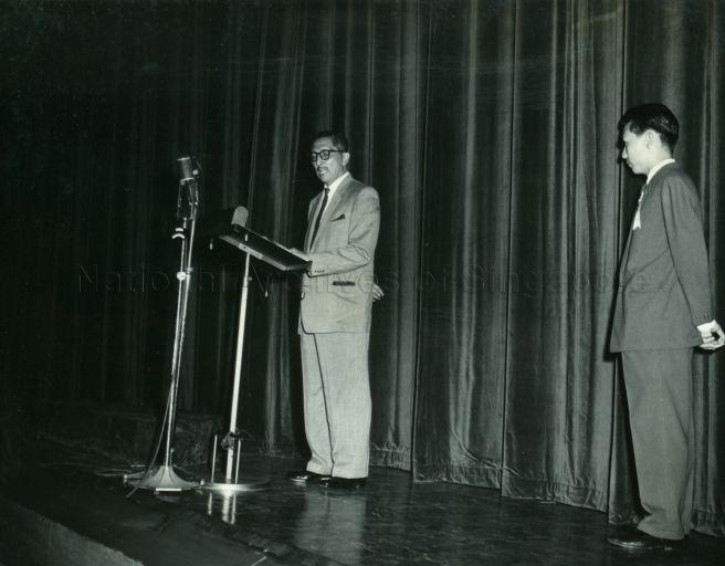 Yang Di-Pertuan Negara Yusof Ishak speaking at the Cultural Festival held at Victoria Theatre. On the right is Kway Wan Thai, Chairman of the Festival's Sub-Committee.