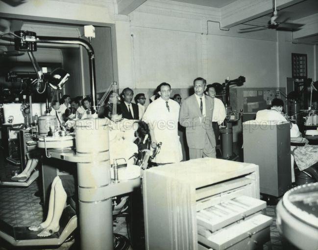 Yang de-Pertuan Negara Encik Yusof bin Ishak is shown round the Dental Clinic in Sepoy Lines by Prof. John Alfred Jansen.