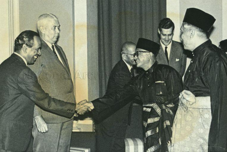 Yang Di-Pertuan Negara Yusof Ishak (right) introducing Minister for Culture S Rajaratnam to Raja Tun Uda, Governor of Penang. Looking on is Minister for Health and Law K M Byrne.