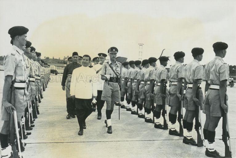 Prince Norodom Sihanouk of Cambodia, accompanied by Yang Di-Pertuan Negara Yusof Ishak, inspecting Guard of Honour at Singapore International Airport before his departure