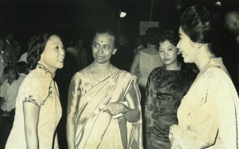 Puan Noor Aishah interacting with artist Georgette Li Ying Chen (left) and other guests at a Malaysia Day reception at Istana Negara