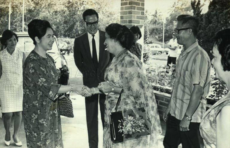 Puan Noor Aishah, with Minister for Health Yong Nyuk Lin, on her arrival at the children's Christmas party at Trafalgar Home