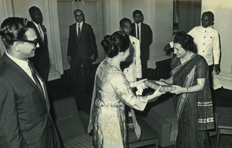 Mrs Indira Gandhi, Prime Minister of India, receiving a gift from Puan Noor Aishah during her courtesy call at the Istana