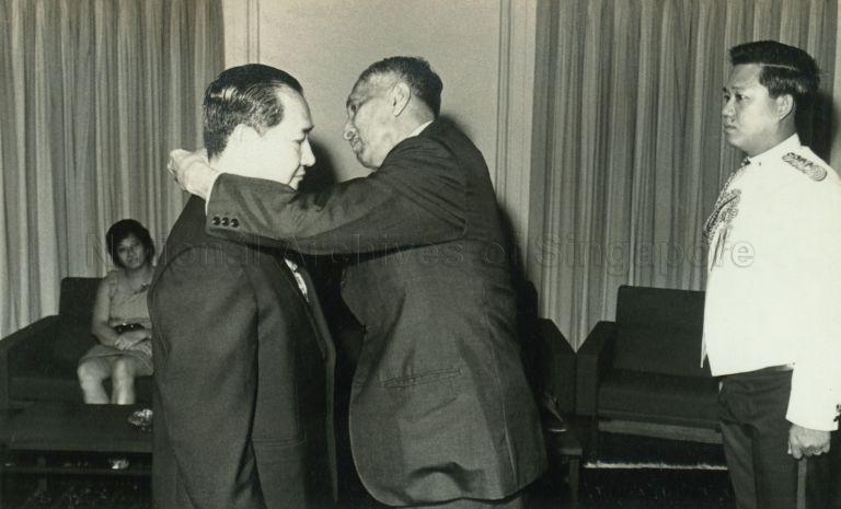 Private presentation of distinguished service medal to Howe Yoon Chong, Chief Executive Officer of the Housing and Development Board, by President Yusof Ishak at the Istana