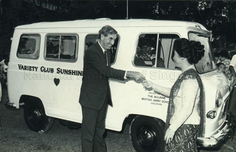 Puan Noor Aishah receiving keys to a van donated to the Singapore Association for Retarded Children by the Bourne British Army School