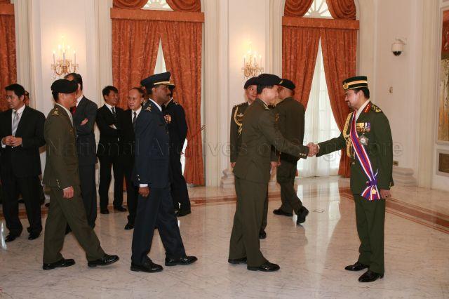 Crown Prince of Brunei Darussalam General Haji Al-Muhtadee Billah (right) being congratulated upon his conferment of Distinguished Service Order (Military) by President S R Nathan at Istana