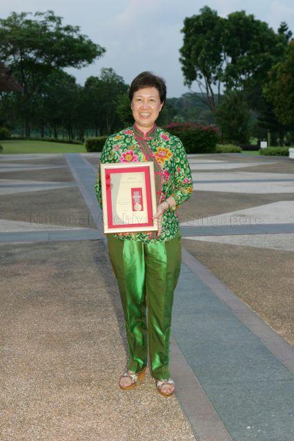 Wife of Prime Minister, Madam Ho Ching holding the Medal of Commendation (Gold) award which she received for her support of the work of unions and for safeguarding workers' interests in Singapore during May Day Dinner at Orchid Country Club